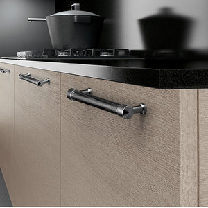 In-use view of black oak bar cabinet pull with silver-colored mounts, style #5 (128 mm).