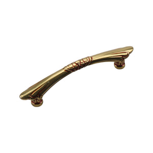 Antique gold-tone curved bar pull with ring bands at the center and tapered ends, 96 mm.