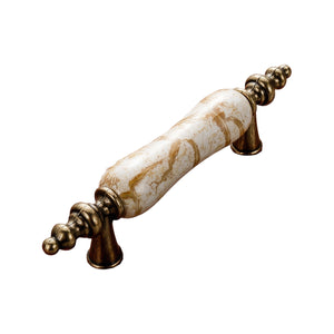 Antique bronze-tone bar pull with a white marble-look grip and ornate finials, option No. 11, 76 mm.