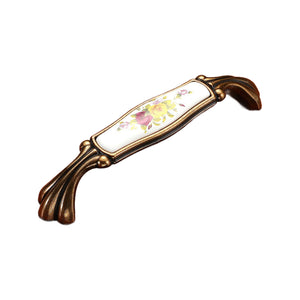 Brown bar pull with a white floral panel and fluted ends, option No. 21, 128 mm.