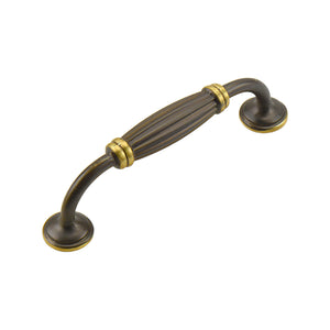 Coffee-tone arched bar pull with a ribbed center and gold-tone rings, 96 mm.