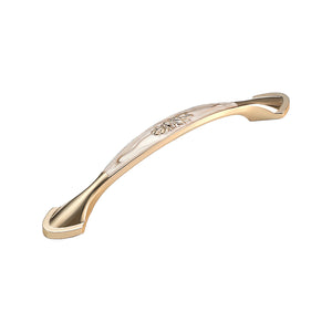 Curved bar pull with a pale central panel and floral detail, option #5.