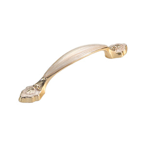Curved bar pull with a pale central grip and ornate ends, option #6, 128 mm.