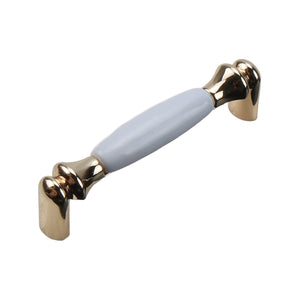 Gold-tone bar pull with a smooth white ceramic grip, option No. 7, 106 mm.
