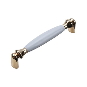 Gold-tone bar pull with a smooth white ceramic grip, option No. 7, 139 mm.