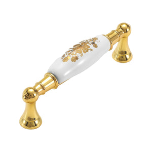 Bar pull with a white floral-patterned grip and gold-tone pedestal mounts, option #6, 96 mm.