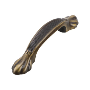 Antique bronze-tone curved bridge pull with sculpted ends, 64 mm, option No. 1.