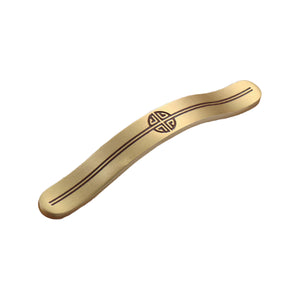 Brass-tone curved bridge pull with a central round motif, 128 mm, option No. 1.