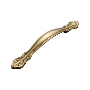 Curved gold-tone bridge pull with ornate floral end plates, option #7, 128 mm.