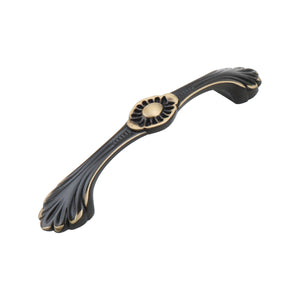 Dark antique-tone arched bridge pull with a floral center and fan-shaped ends, 128 mm, option No. 10.
