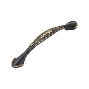 Dark antique-tone arched bridge pull with a gold-tone leaf center, 128 mm, option No. 11.