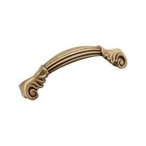 Rose gold-tone arched bridge pull with a fluted bar and scroll ends, 72 mm.