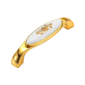 Curved gold-tone bridge pull with a white floral inset, option #7, 128 mm.