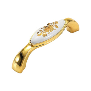 Curved gold-tone bridge pull with a white floral inset, option #7, 96 mm.