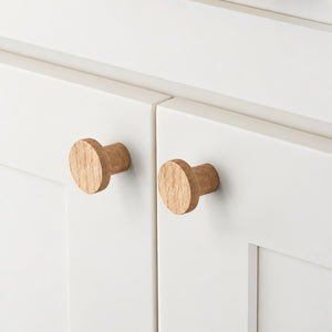 In-use view of flat round white oak cabinet knob, style #1 (33 mm).