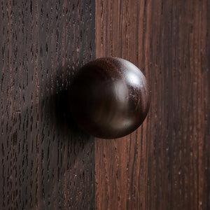 In-use view of round walnut wood cabinet knob, style #1 (40 mm).