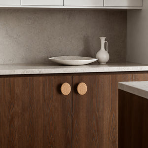 In-use view of flat round white oak cabinet knob, style #1 (48 mm).