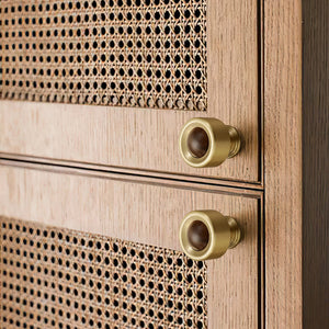 In-use view of brass cup cabinet knob with a dark wood ball inset, style #1.