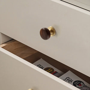 In-use view of dark wood mushroom cabinet knob on a brass pedestal, style #1.