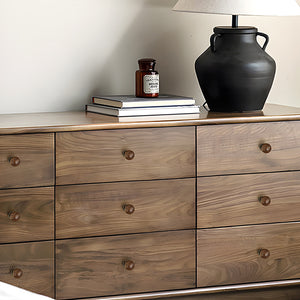 In-use view of dark wood ball cabinet knob with antique bronze brass base, style #10 (25 mm).