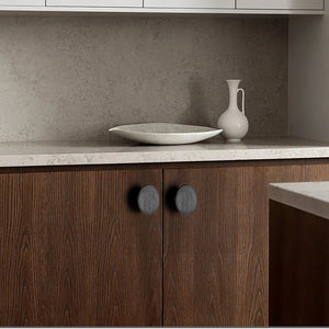 In-use view of flat round black oak cabinet knob, style #2 (48 mm).