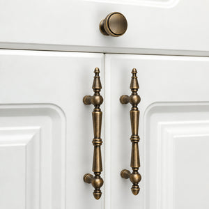 In-use view of recessed round antique bronze brass cabinet knob, style #21.