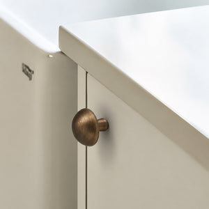 Bronze-finish solid brass round cabinet knob, style #4 shown in a styled setting.