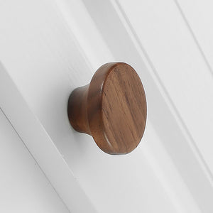 In-use view of walnut wood mushroom cabinet knob with a flat round top, style #4.