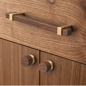 In-use view of walnut wood cylindrical cabinet knob with brass base, style #6.