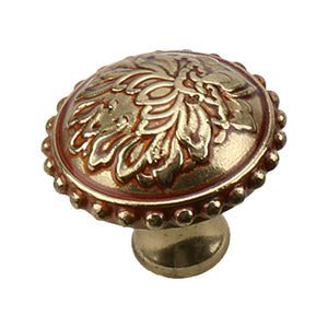 Antique gold-tone round cabinet knob with raised floral detail and a beaded rim, 32 mm.