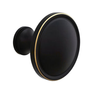 Black round cabinet knob with a dark face and brass-tone rim.