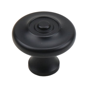 Black round cabinet knob with concentric rings and a raised center, option No. 1.