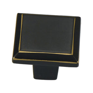 Black square cabinet knob with a fine gold-tone border, option No. 1.