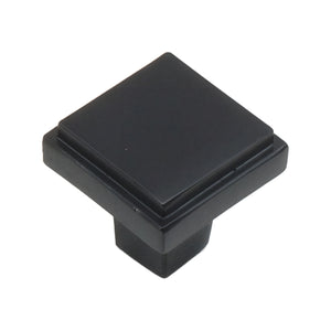 Black square cabinet knob with a stepped rim and flat top, option No. 3.