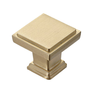 Brass-tone square cabinet knob with a flat top and stepped edge, option No. 2.