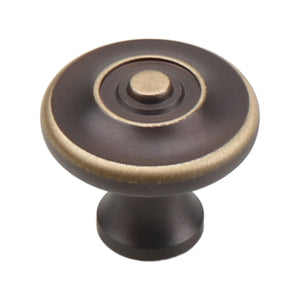Coffee brown round cabinet knob with a gold-tone rim and raised center, option No. 1.
