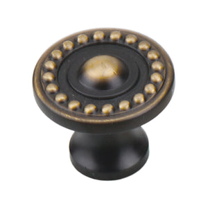 Dark antique-tone round cabinet knob with a raised center and gold-tone beaded ring, option No. 2.