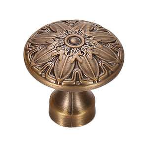 Round cabinet knob with raised floral relief and a central button, variant #4.