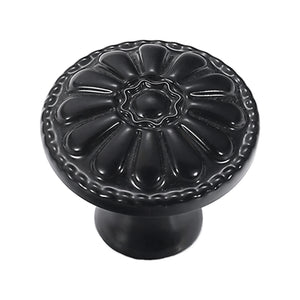 Black floral cabinet knob with a raised petal design, variant #1.