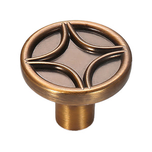 Round cabinet knob with four curved raised motifs, variant #8.