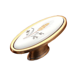 Bronze-tone oval cabinet knob with a wheat motif on a white center, option No. 20, 58 mm.