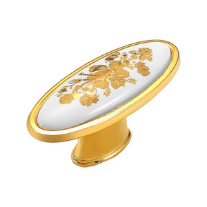 Oval white cabinet knob with a gold-tone floral pattern, option #3.