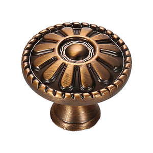 Round cabinet knob with raised radial petals, a domed center and a beaded rim, variant #1.