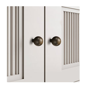 Two spherical bronze-finish brass knobs installed on white cabinet doors.