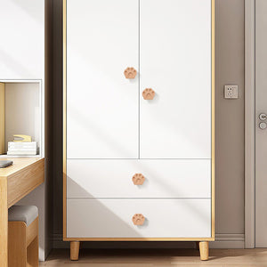 Paw-shaped wood knobs on a white chest.