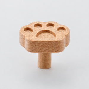 Multiple views of paw-shaped wood cabinet knob or wall hook, style #12.