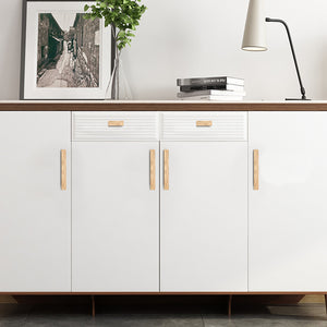 Natural oak wood finger pulls fitted to a white sideboard.