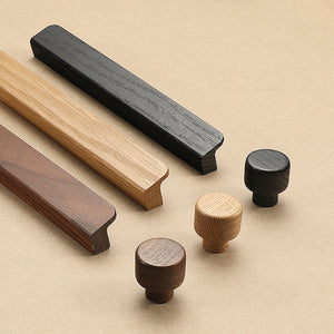 Curved wood finger pulls and round knobs in natural, walnut and black finishes.