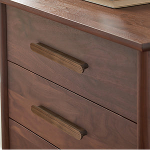 Walnut wood slim cabinet finger pull installed on cabinetry.