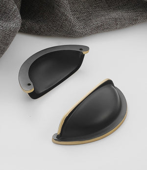 Front and back views of the solid brass open-back cup pull in Blackened Bronze, showing its curved face and two mounting holes.